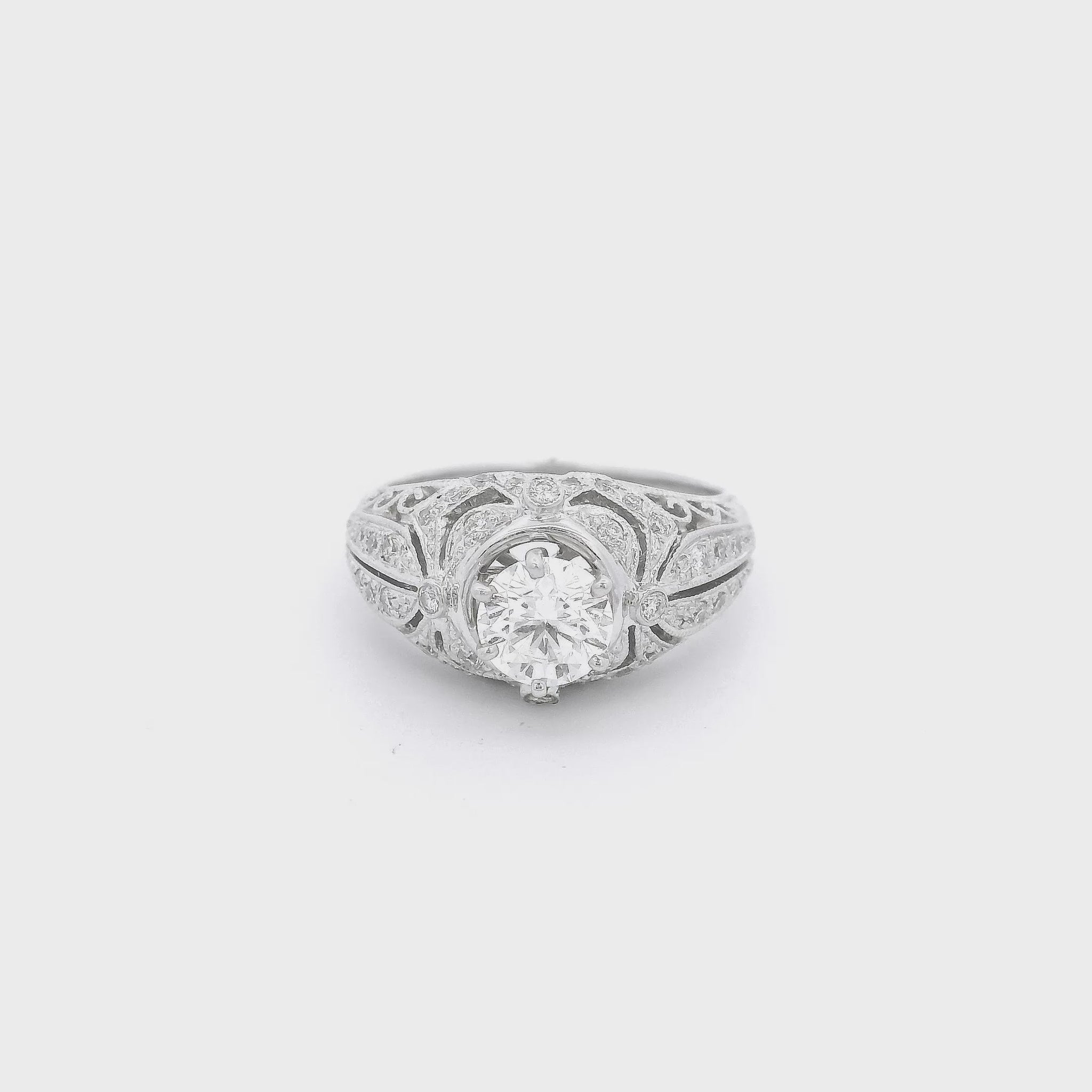 White Gold ring with a round cut diamond set in the cetner and some diamond accents on the filigree hand carved ring at Foreever Rox Fine Jewelry