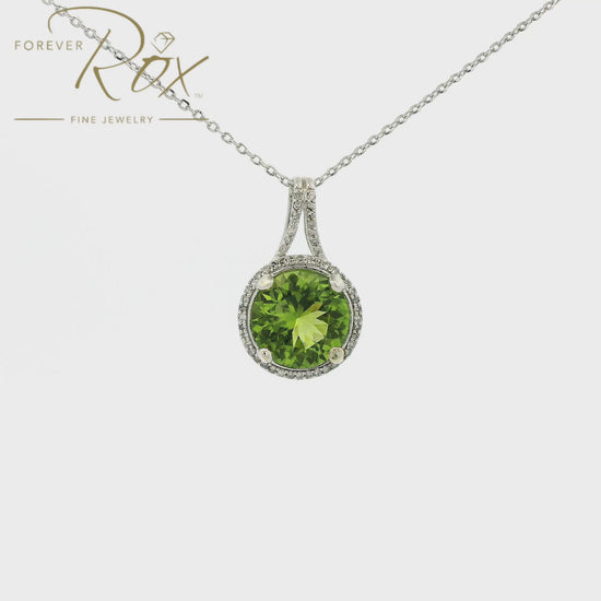 A White Gold Pendant with a prong set round cut natural Sapphire in the center with a halo of diamonds at Forever Rox Fine Jewelry, Lake Tahoes Best Jewelry Store