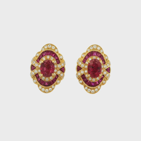 A Pair of Yellow Gold Earrings with prong set oval cut natural Rubies in the center with french cut rubies and diamonds around them at Forever Rox Fine Jewelry, Lake Tahoes Best Jewelry Store