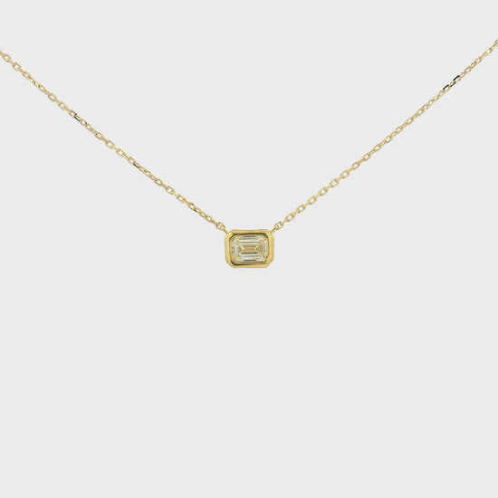 A Yellow Gold Pendant with a bezel set emerald cut natural Diamond in the center at Forever Rox Fine Jewelry, Lake Tahoes Best Jewelry Store
