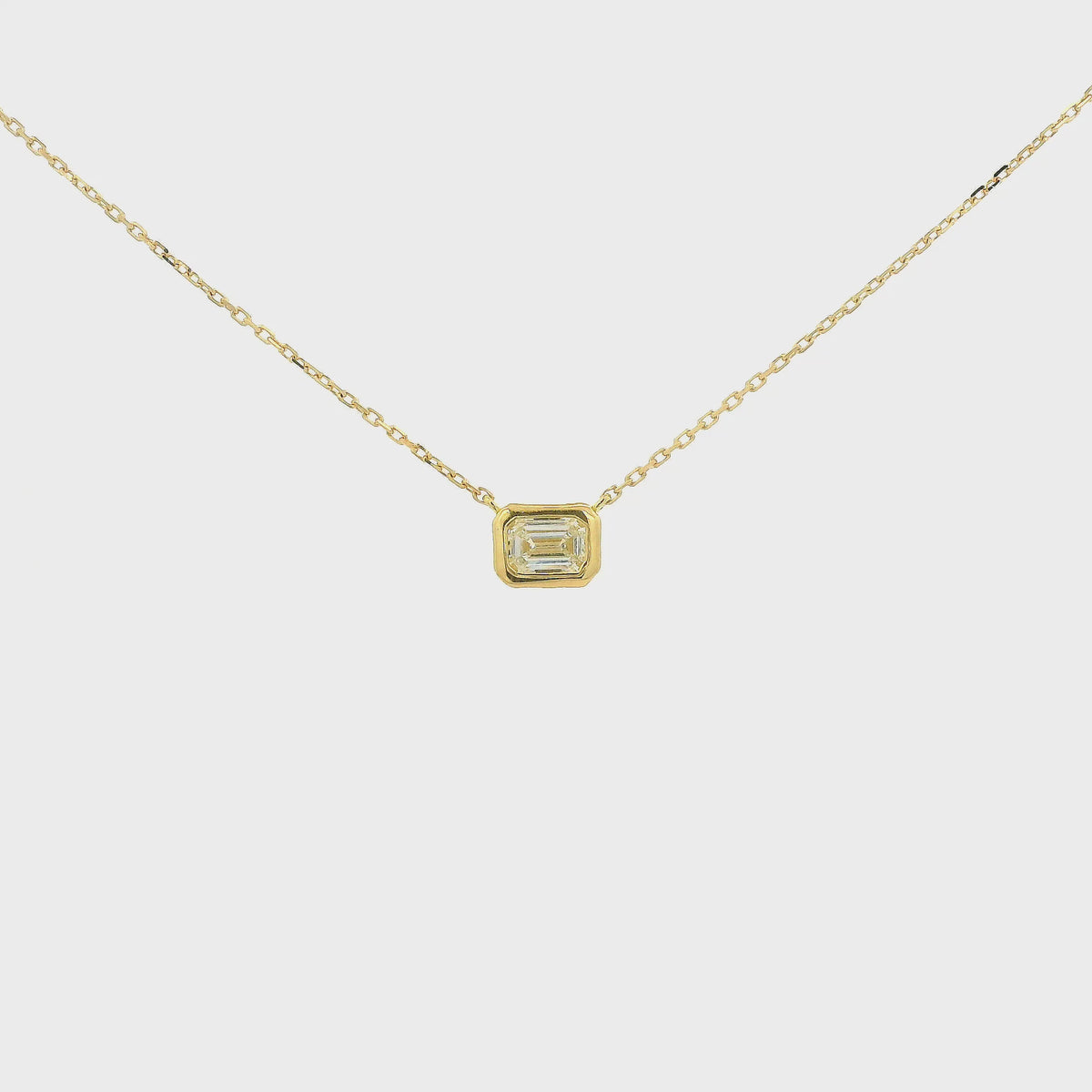 A Yellow Gold Pendant with a bezel set emerald cut natural Diamond in the center at Forever Rox Fine Jewelry, Lake Tahoes Best Jewelry Store
