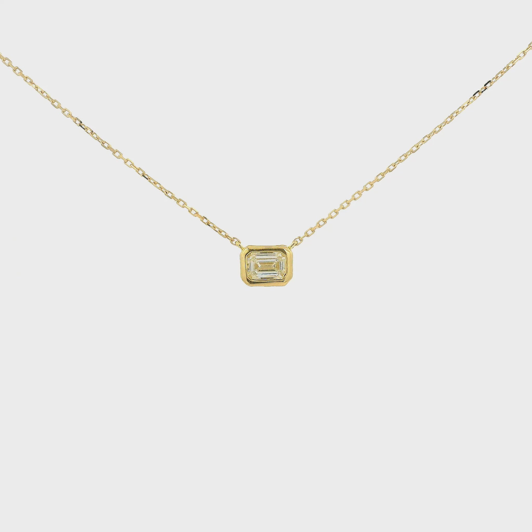 A Yellow Gold Pendant with a bezel set emerald cut natural Diamond in the center at Forever Rox Fine Jewelry, Lake Tahoes Best Jewelry Store
