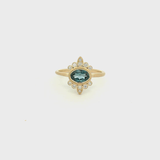 A Yellow Gold Ring with a bezel set oval cut natural London Blue Topaz in the center with diamond bursts at Forever Rox Fine Jewelry, Lake Tahoes Best Jewelry Store
