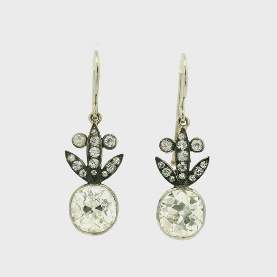 A Pair of White Gold Victorian Dangle Earrings with bezel set old mine cut natural Diamonds in the center with diamonds dangling down at Forever Rox Fine Jewelry, Lake Tahoes Best Jewelry Store