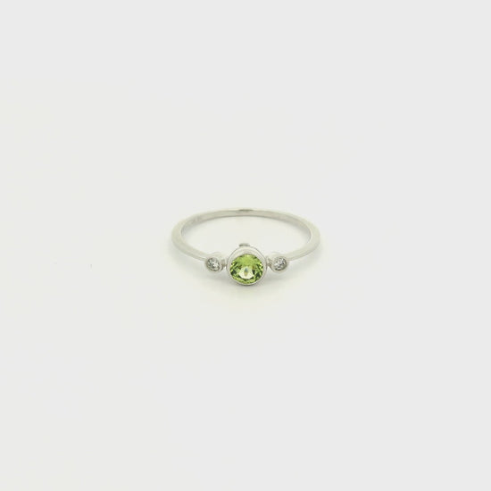 A White Gold Ring with a milgrain bezel set round cut natural Peridot in the center with 2 bezel set Natural Diamonds at Forever Rox Fine Jewelry, Lake Tahoes Best Jewelry Store
