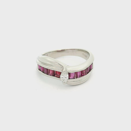 A Platinum Ring with a prong set marquise  cut natural Diamond in the center with princess cut rubies down each side at Forever Rox Fine Jewelry, Lake Tahoes Best Jewelry Store