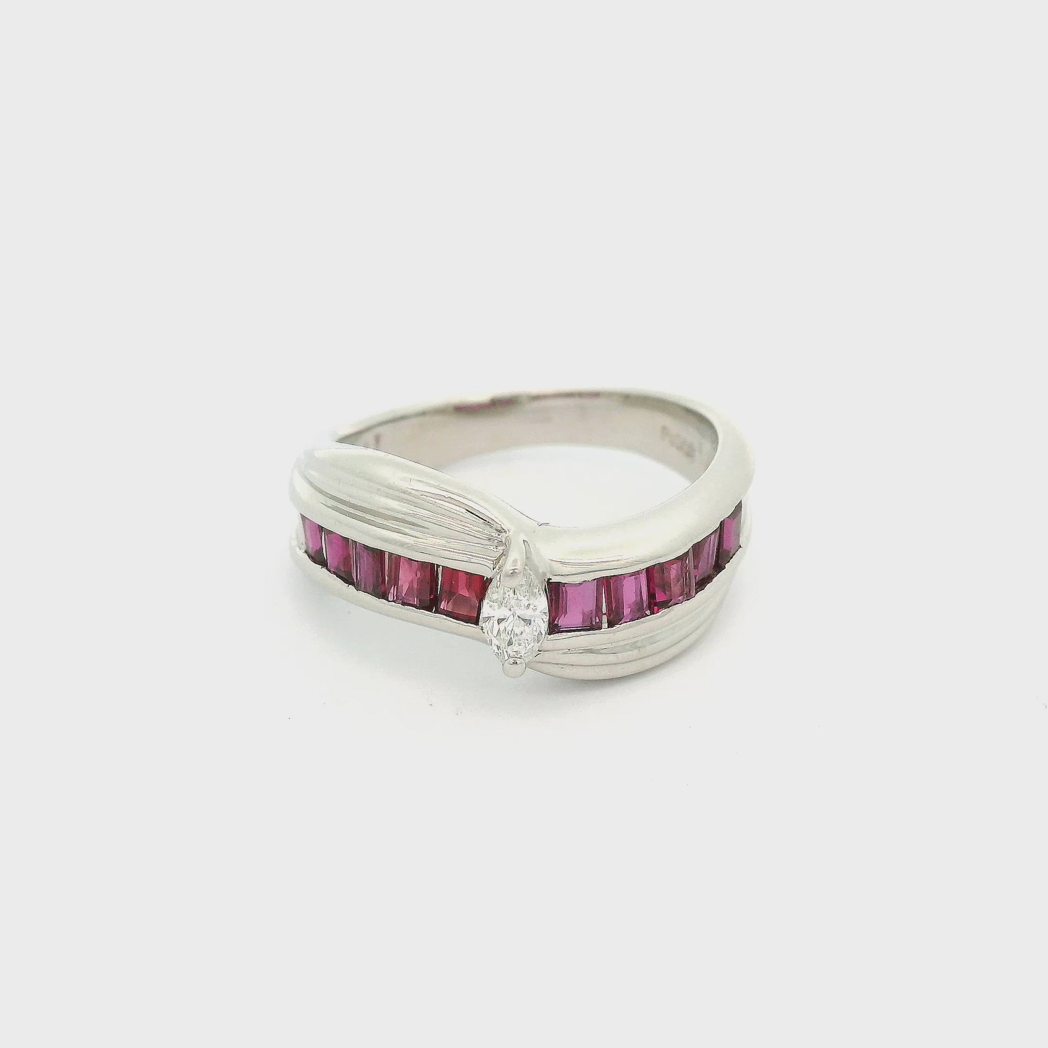 A Platinum Ring with a prong set marquise  cut natural Diamond in the center with princess cut rubies down each side at Forever Rox Fine Jewelry, Lake Tahoes Best Jewelry Store
