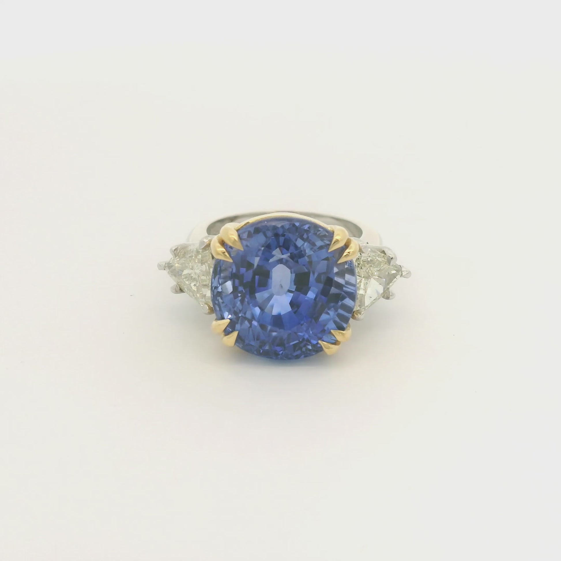 Product #: 69628MU> Stone Weight: 18.95ctw Natural Certified Ceylon Sapphire. Accent Stone: 2.16ctw Natural Trillion Cut Diamonds. Metal: Platinum & 18k Yellow Gold. 

