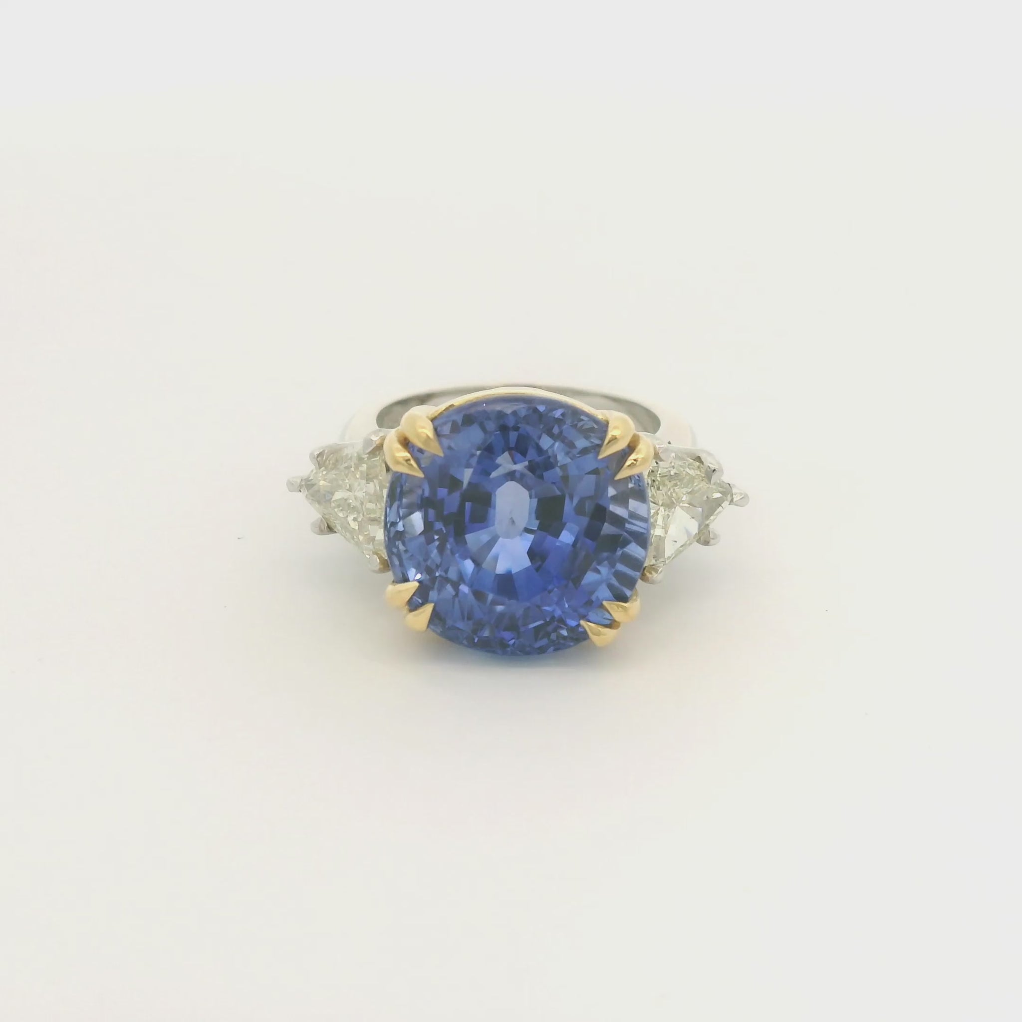 Product #: 69628MU> Stone Weight: 18.95ctw Natural Certified Ceylon Sapphire. Accent Stone: 2.16ctw Natural Trillion Cut Diamonds. Metal: Platinum & 18k Yellow Gold. 
