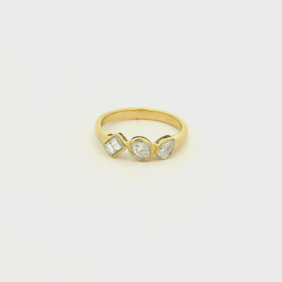 A Yellow Gold Ring with bezel set Emerald, Oval & Pear cut natural Diamonds in the center at Forever Rox Fine Jewelry, Lake Tahoes Best Jewelry Store
