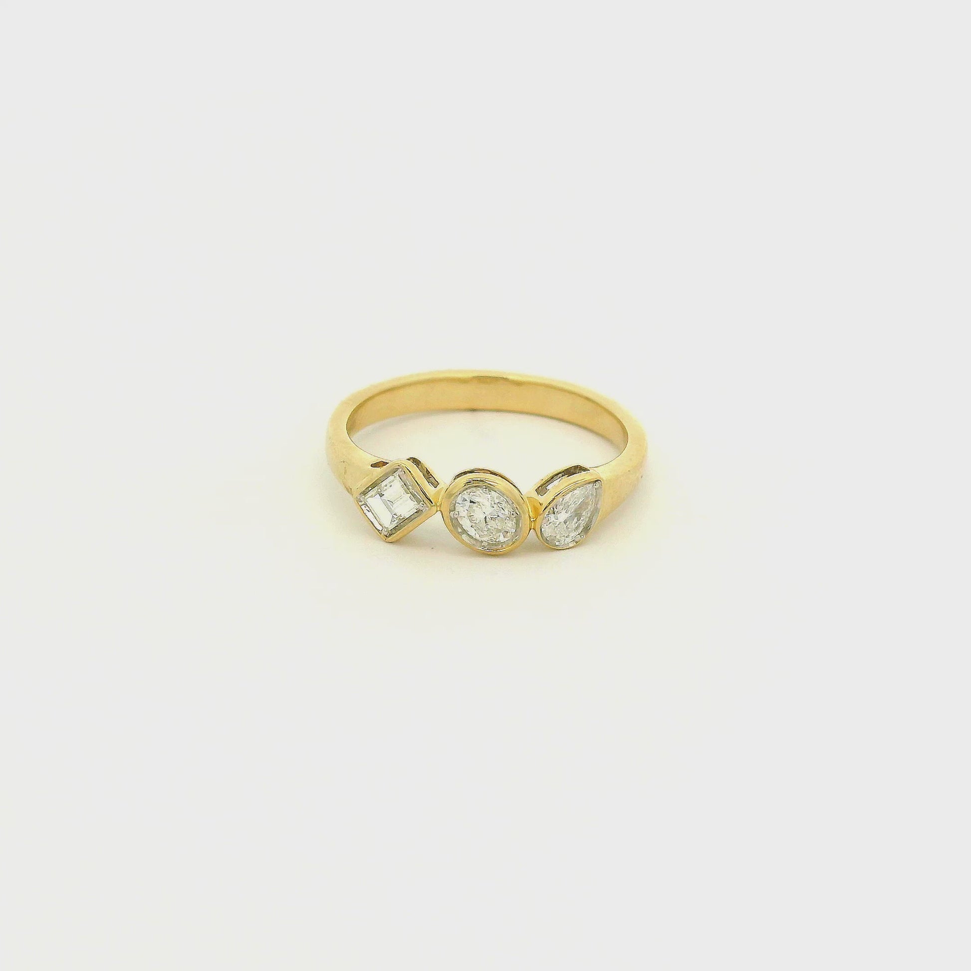 A Yellow Gold Ring with bezel set Emerald, Oval & Pear cut natural Diamonds in the center at Forever Rox Fine Jewelry, Lake Tahoes Best Jewelry Store
