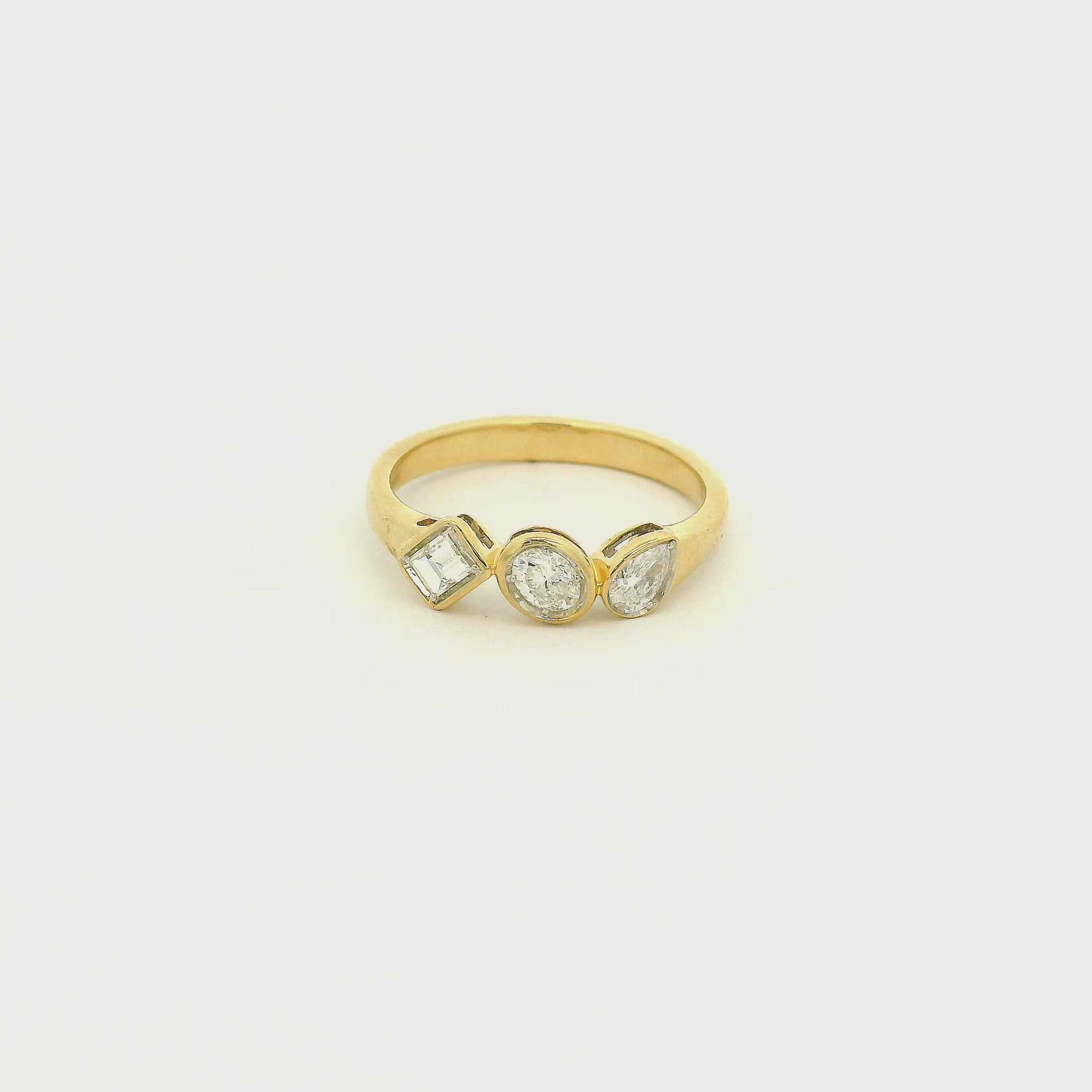 A Yellow Gold Ring with bezel set Emerald, Oval & Pear cut natural Diamonds in the center at Forever Rox Fine Jewelry, Lake Tahoes Best Jewelry Store
