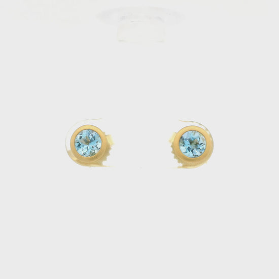 A Pair of Yellow Gold Stud Earrings with bezel set round cut Aquamarines in the center at Lake Tahoes best Jewelry Store, Forever Rox Fine Jewelry