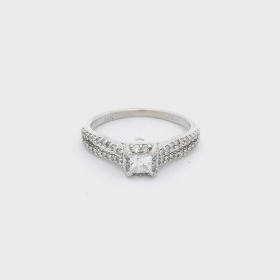 White Gold ring with a princess cut diamond in the center and diamond accent down a split shank and in a halo around the center stone at Forever Rox Fine Jewelry 