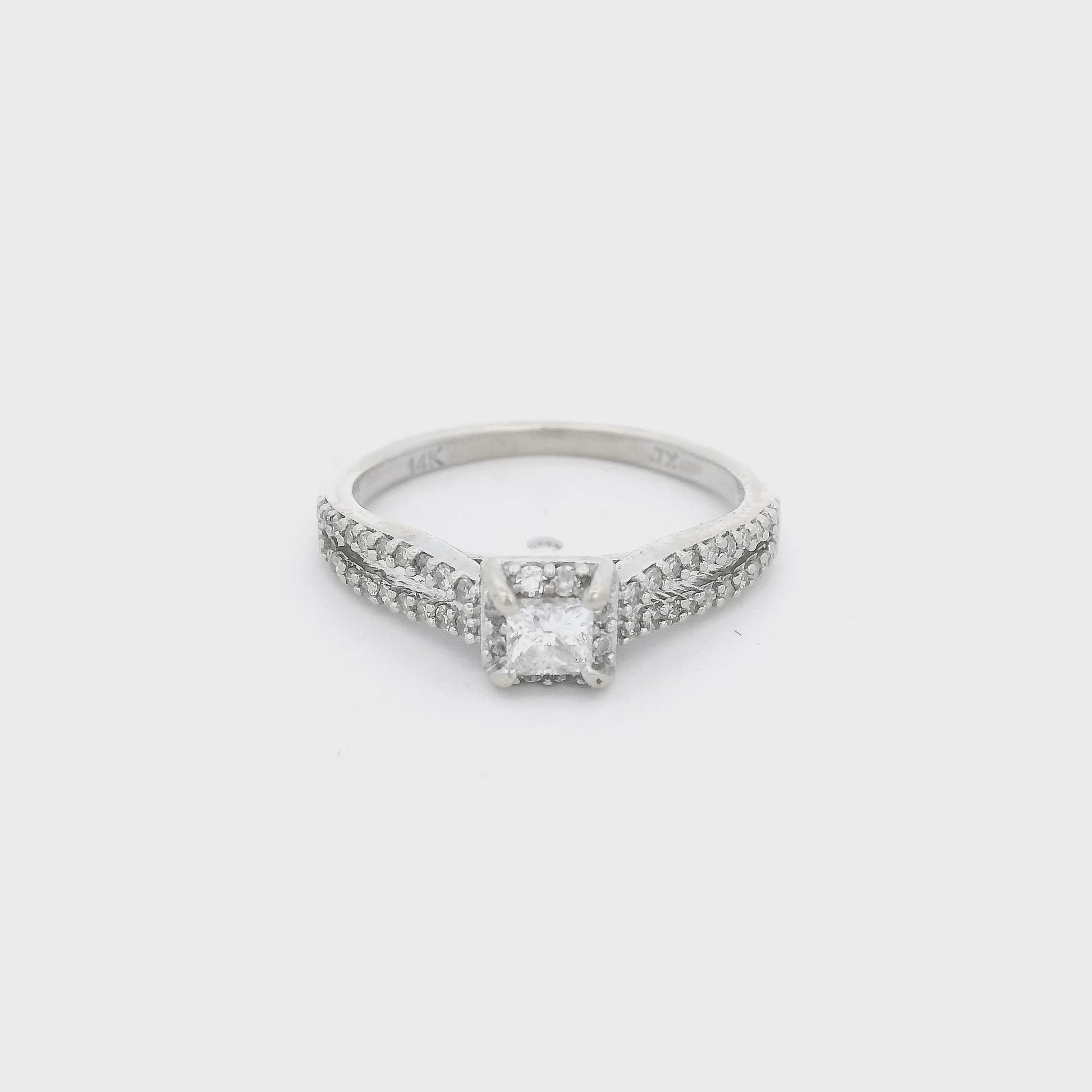 White Gold ring with a princess cut diamond in the center and diamond accent down a split shank and in a halo around the center stone at Forever Rox Fine Jewelry 
