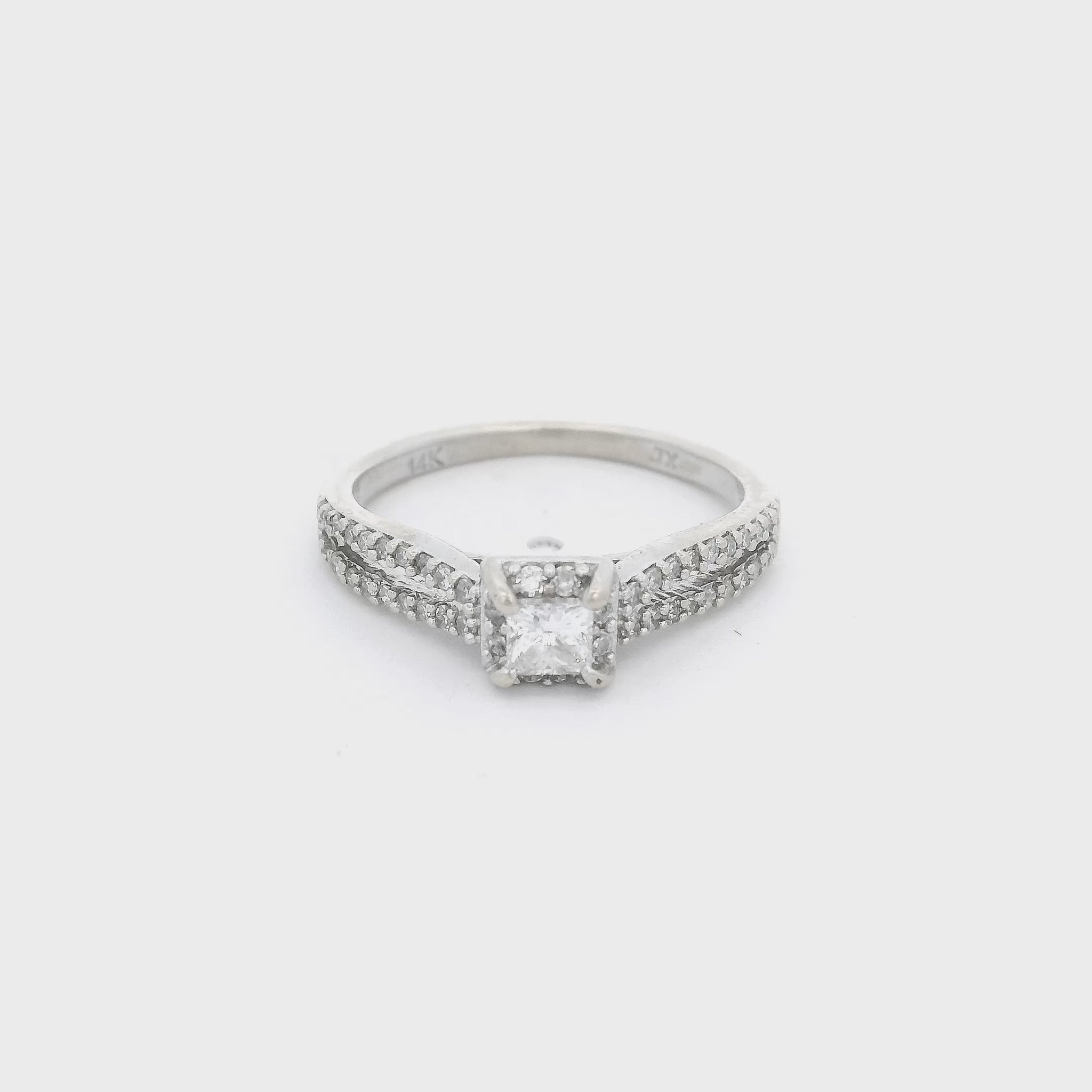 White Gold ring with a princess cut diamond in the center and diamond accent down a split shank and in a halo around the center stone at Forever Rox Fine Jewelry 