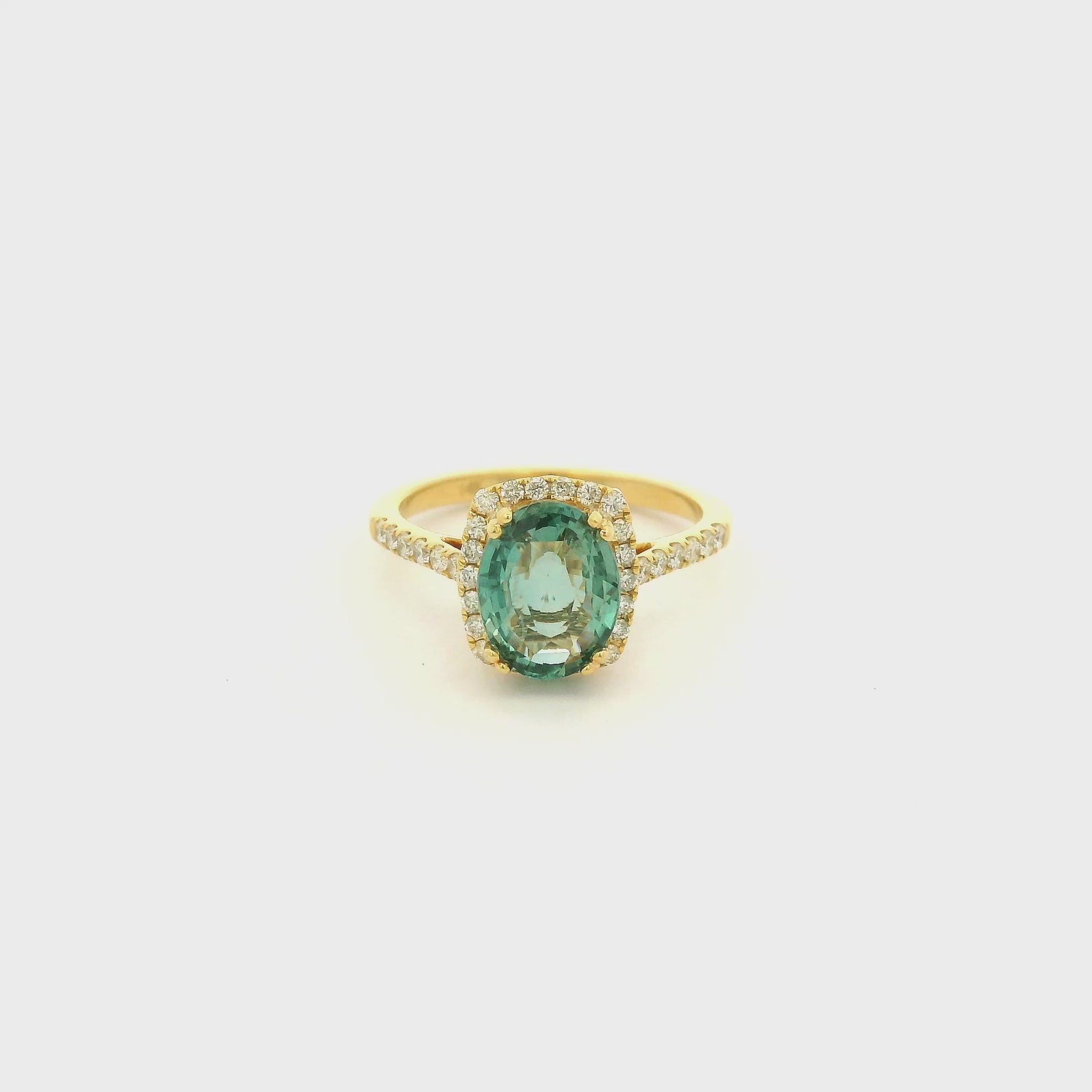 A Yellow Gold Ring with a double prong set oval cut natural certified Alexandrite in the center with a halo of diamonds and diamonds down shank at Forever Rox Fine Jewelry, Lake Tahoes Best Jewelry Store