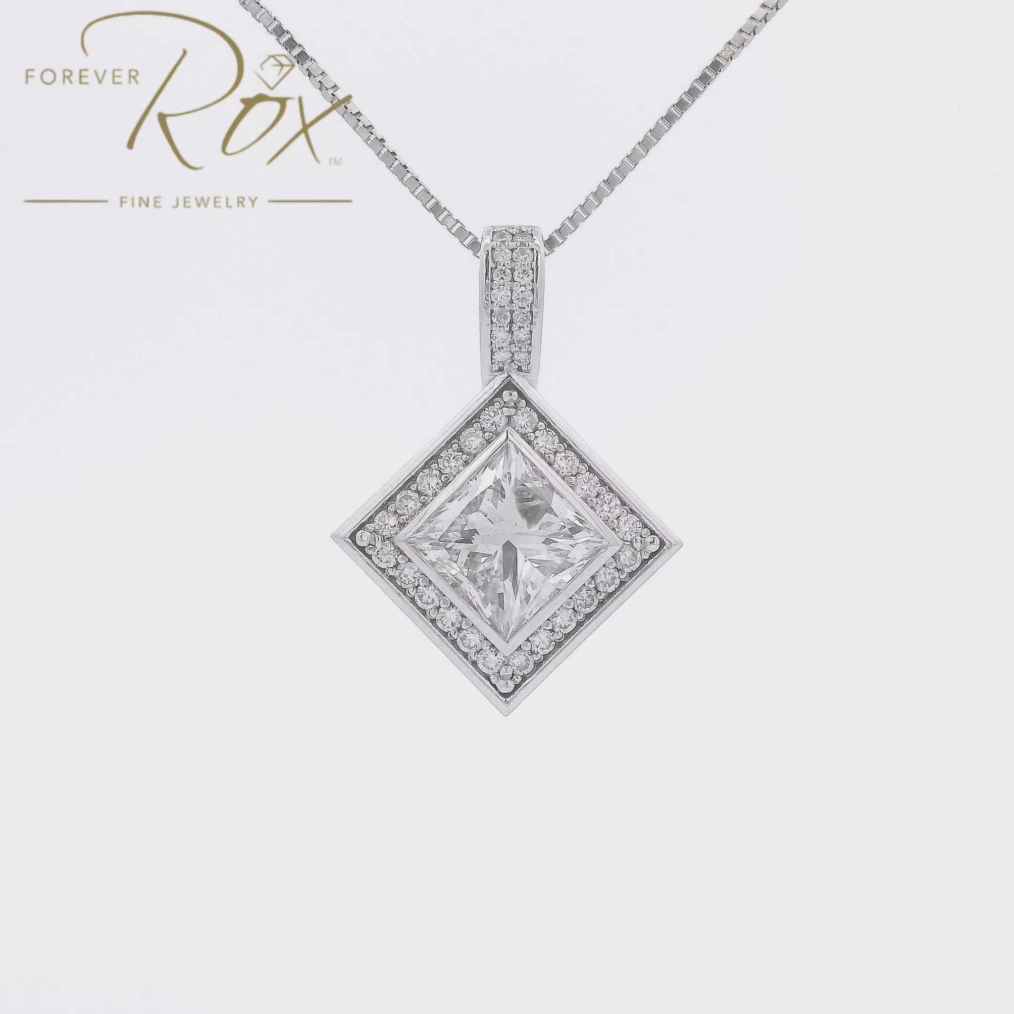 This is a Custom White Gold Bezel Set Princess Cut DIamond Pendant with Channel Set Round Cut Diamond Halo mad at Forever Rox Fine Jewelry, The BEst Jewelry Store in Lake Tahoe