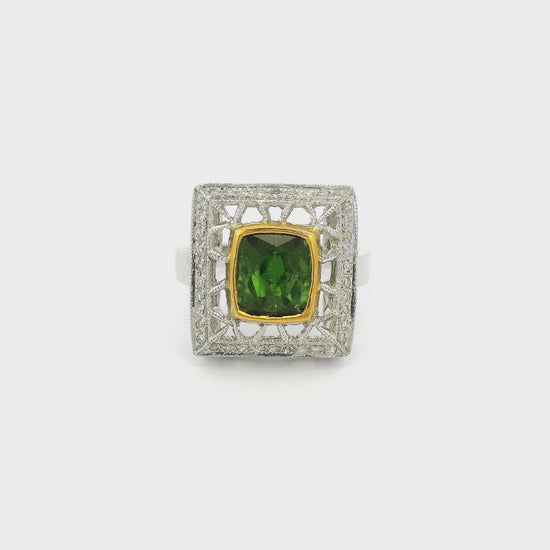 A White Gold Ring with a bezel set cushion cut natural Green Tourmaline in the center with a hand carved head with diamonds at Forever Rox Fine Jewelry, Lake Tahoes Best Jewelry Store