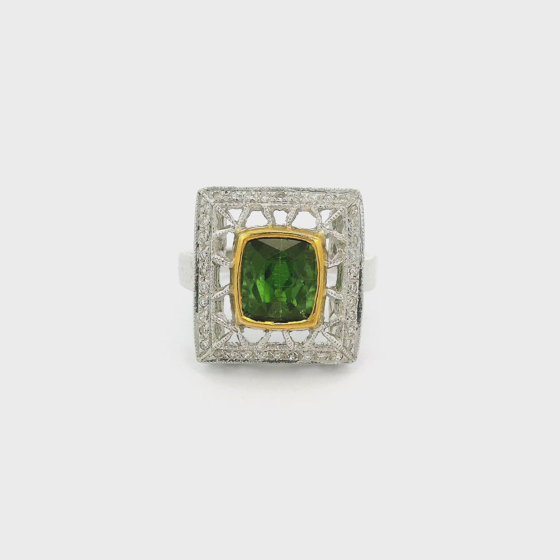 A White Gold Ring with a bezel set cushion cut natural Green Tourmaline in the center with a hand carved head with diamonds at Forever Rox Fine Jewelry, Lake Tahoes Best Jewelry Store
