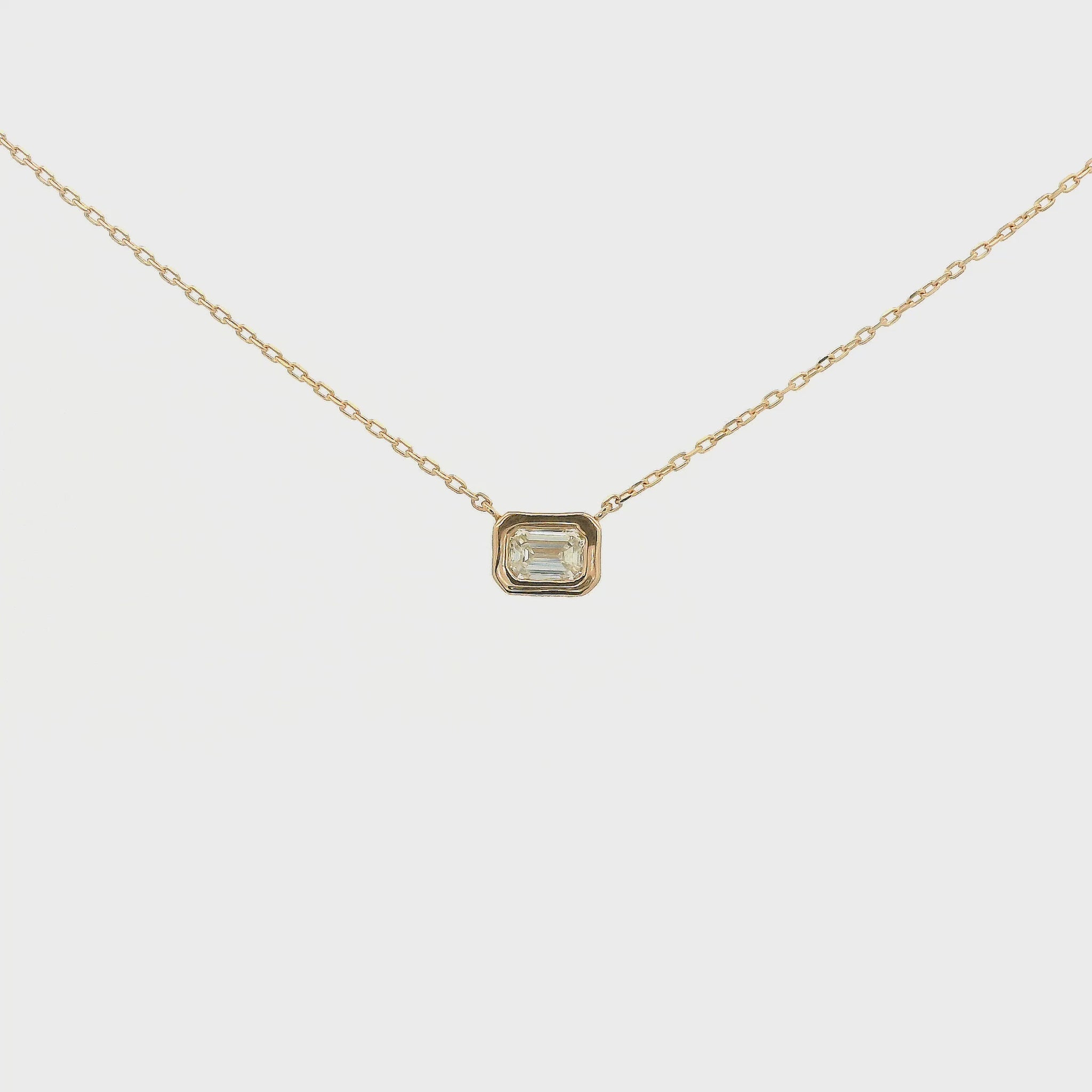 A Rose Gold Pendant with a bezel set emerald cut natural Diamond in the center at Forever Rox Fine Jewelry, Lake Tahoes Best Jewelry Store
