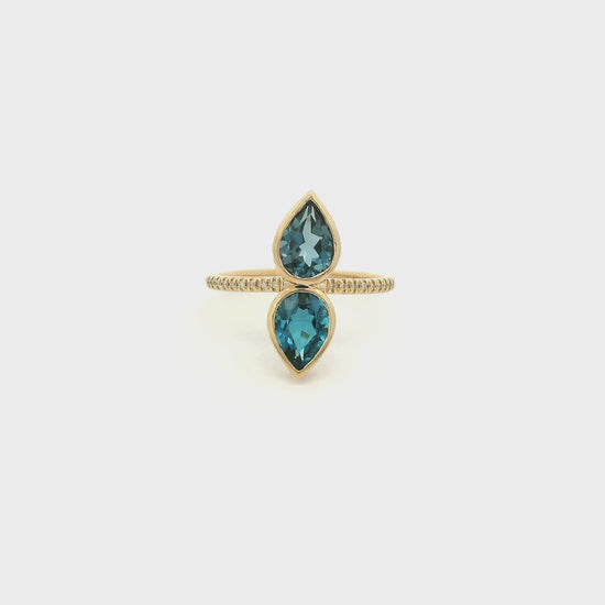 A Yellow Gold Ring with a two bezel set pear cut natural London Blue Topaz in the center withdiamonds down the shank at Forever Rox Fine Jewelry, Lake Tahoes Best Jewelry Store