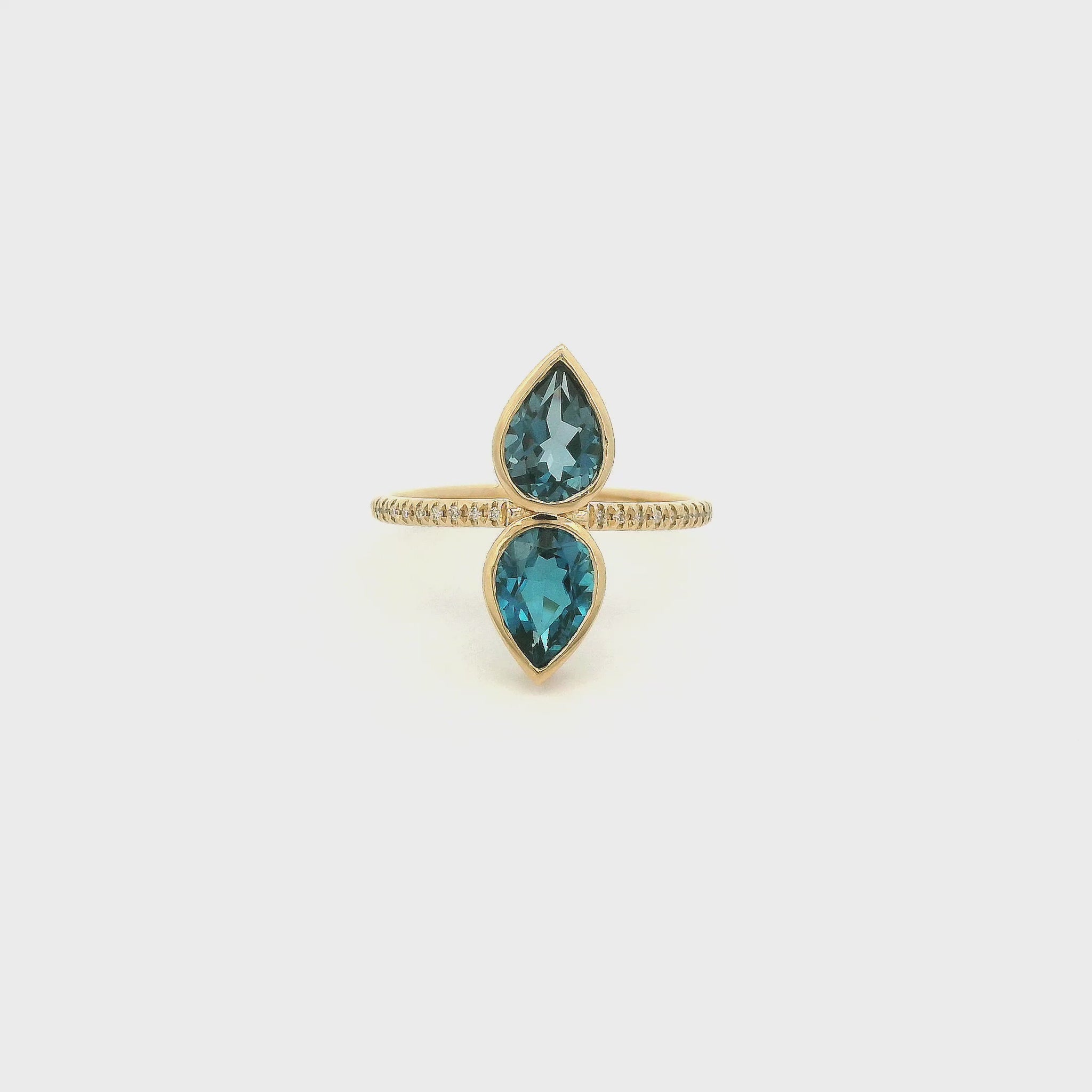 A Yellow Gold Ring with a two bezel set pear cut natural London Blue Topaz in the center withdiamonds down the shank at Forever Rox Fine Jewelry, Lake Tahoes Best Jewelry Store