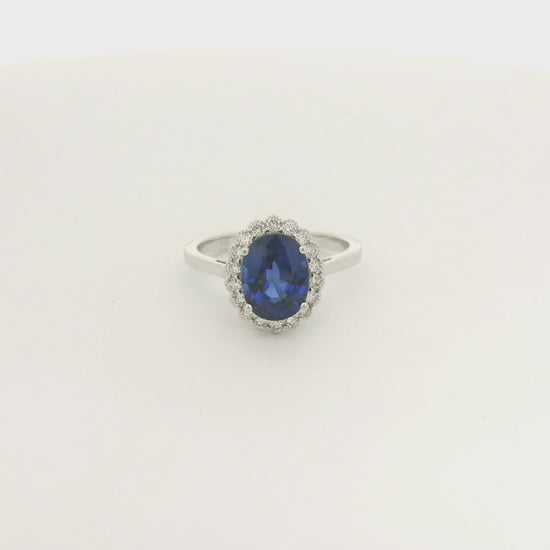 A White Gold Ring with a prong set oval cut natural Ceylon Sapphire in the center with a diamond halo with milgrain at Forever Rox Fine Jewelry, Lake Tahoes Best Jewelry Store