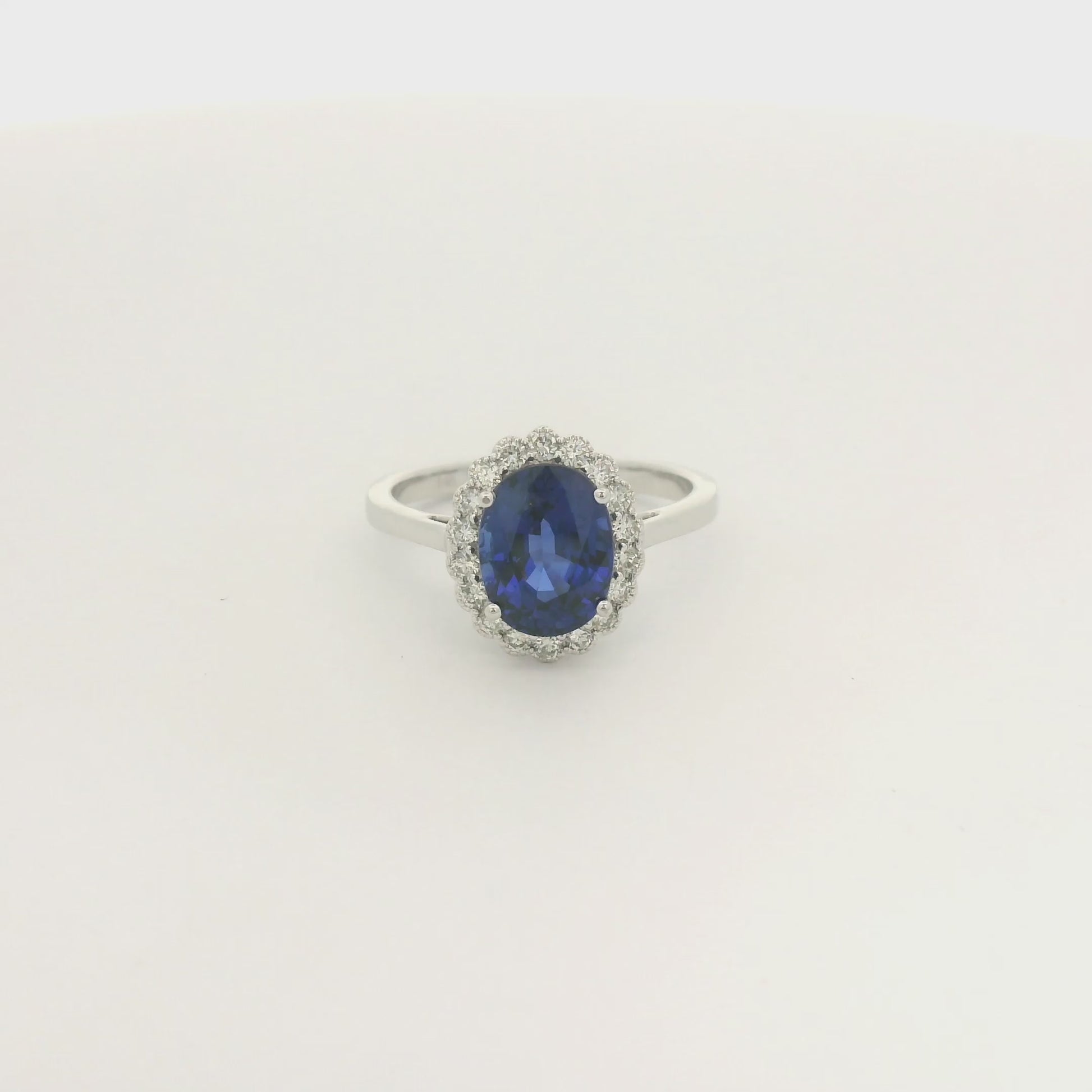 A White Gold Ring with a prong set oval cut natural Ceylon Sapphire in the center with a diamond halo with milgrain at Forever Rox Fine Jewelry, Lake Tahoes Best Jewelry Store