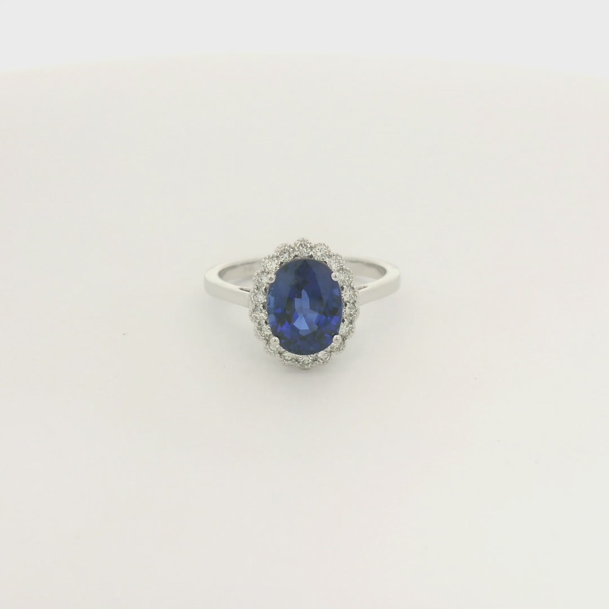 A White Gold Ring with a prong set oval cut natural Ceylon Sapphire in the center with a diamond halo with milgrain at Forever Rox Fine Jewelry, Lake Tahoes Best Jewelry Store