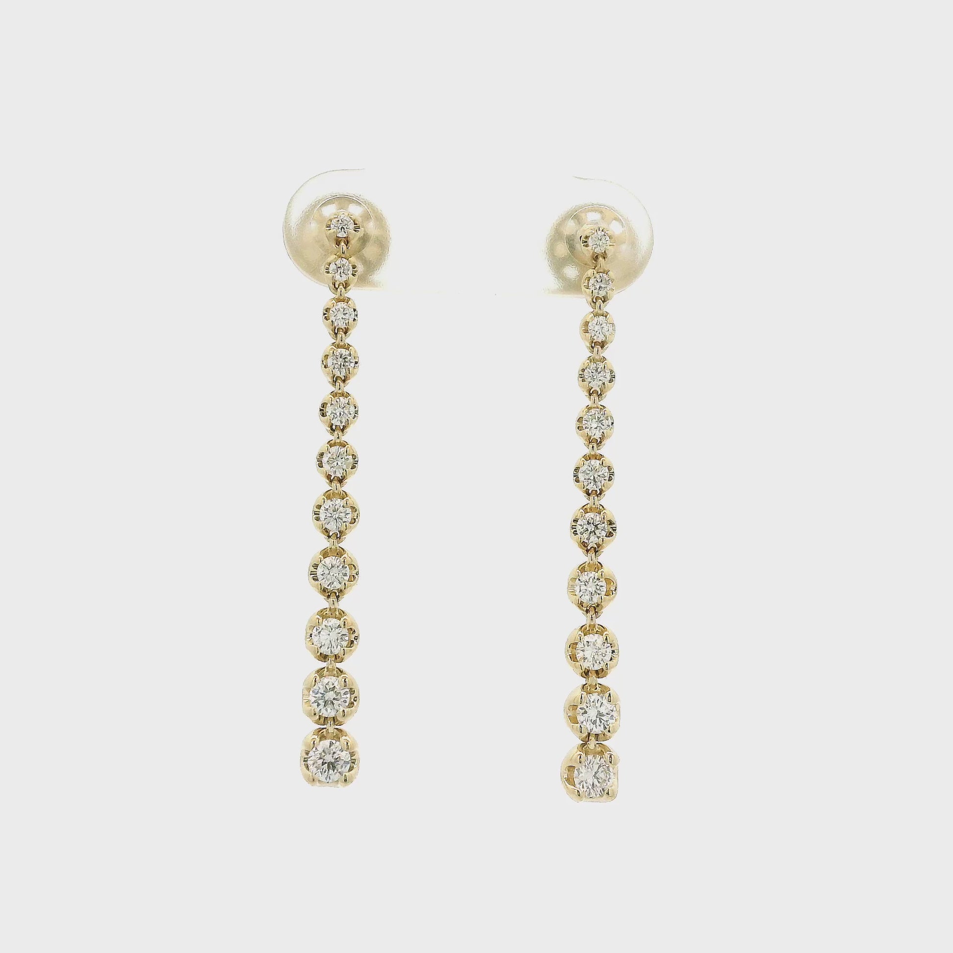 A Pair of Yellow Gold Dangle Earrings with graduating size bezel set round cut natural diamonds at Forever Rox Fine Jewelry, Lake Tahoes Best Jewelry Store
