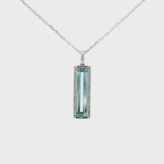 A White Gold Pendant with a long prong set emerald cut natural Topaz in the center with a halo of diamonds at Forever Rox Fine Jewelry, Lake Tahoes Best Jewelry Store