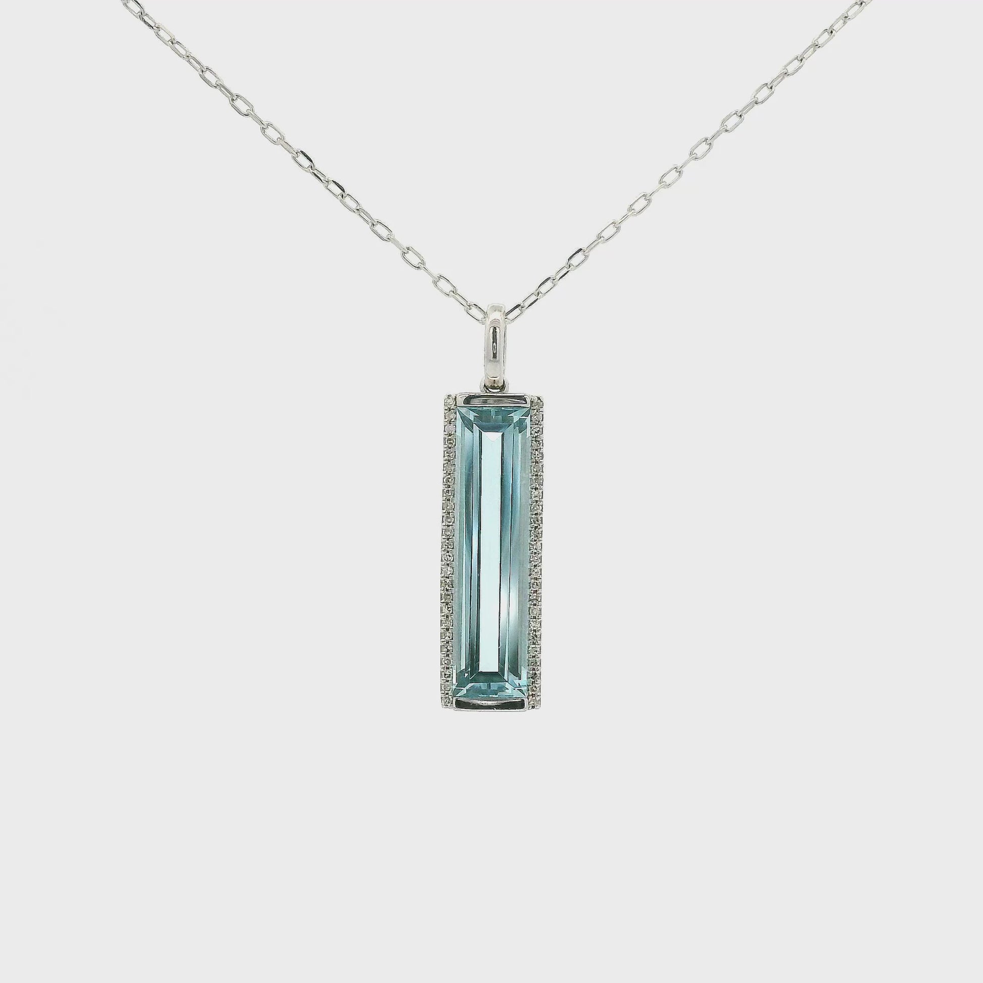 A White Gold Pendant with a long prong set emerald cut natural Topaz in the center with a halo of diamonds at Forever Rox Fine Jewelry, Lake Tahoes Best Jewelry Store