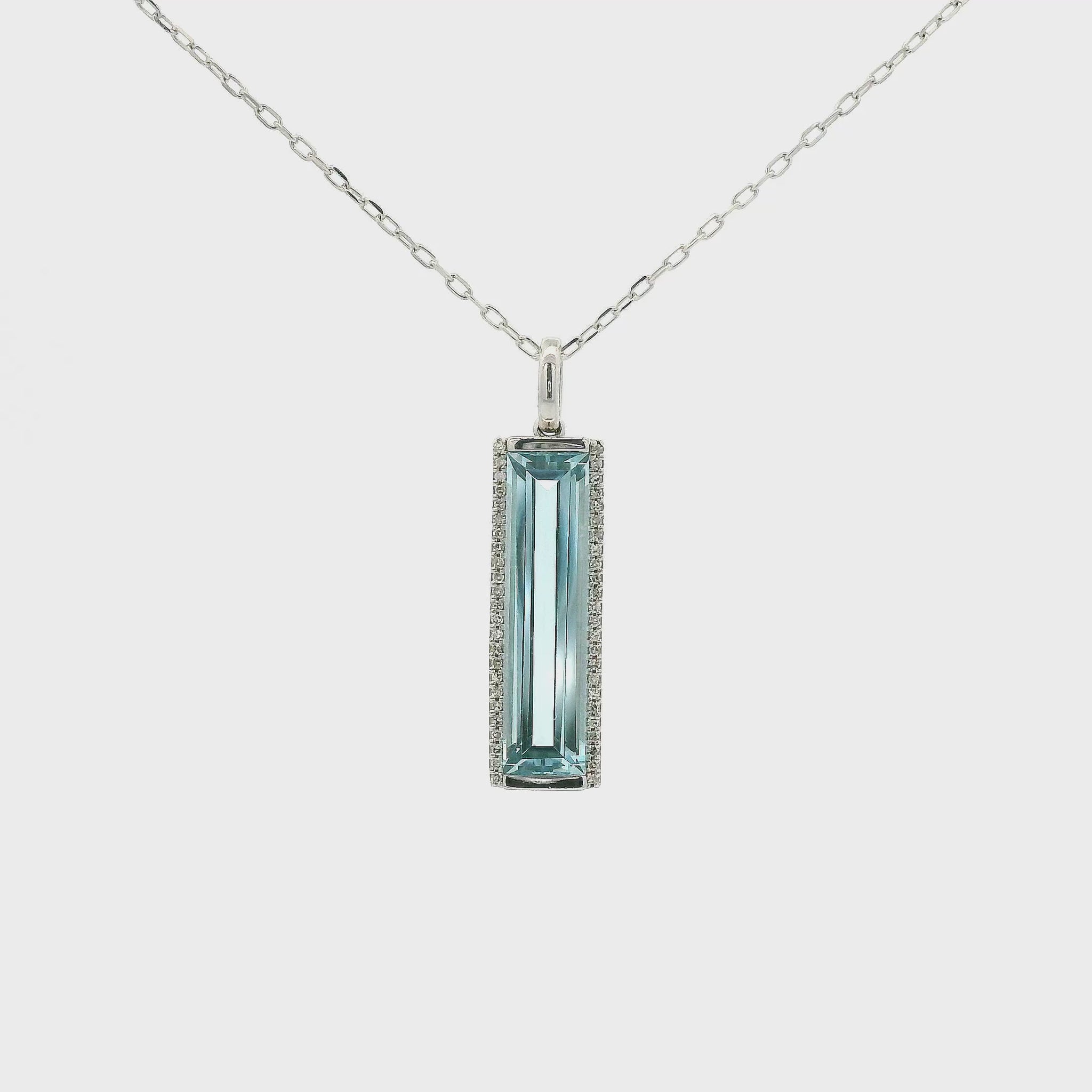 A White Gold Pendant with a long prong set emerald cut natural Topaz in the center with a halo of diamonds at Forever Rox Fine Jewelry, Lake Tahoes Best Jewelry Store
