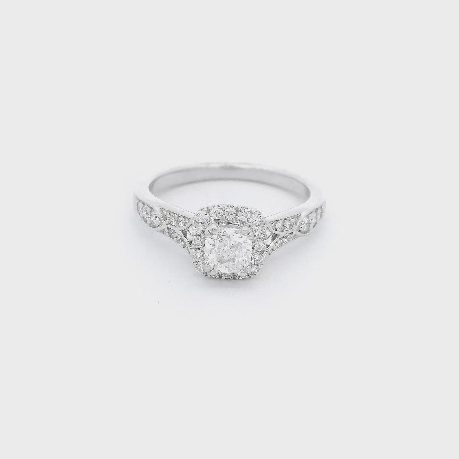 White gold ring with hand carved designs and diamonds with a diamond set in the center at Forever Rox Fine Jewelry