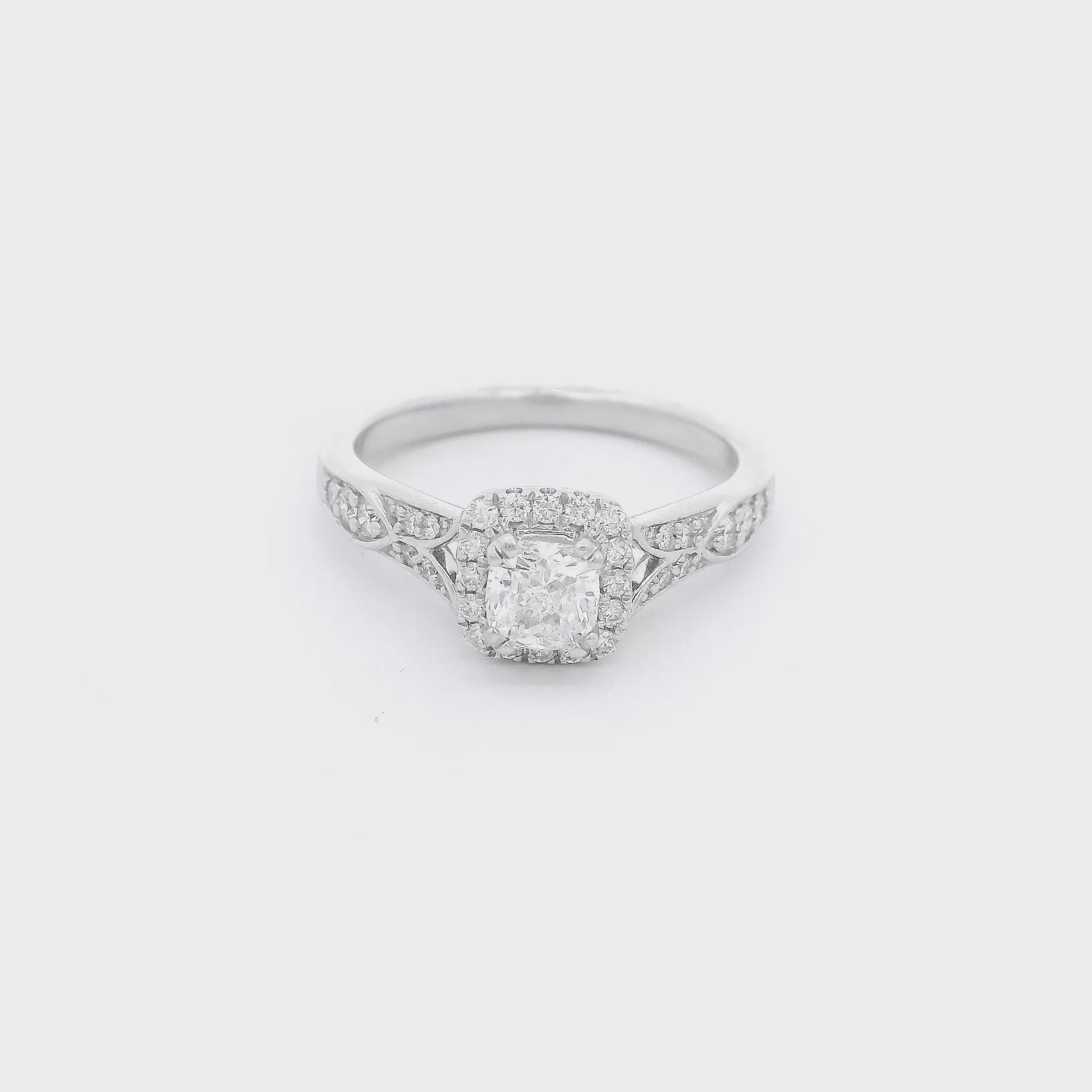White gold ring with hand carved designs and diamonds with a diamond set in the center at Forever Rox Fine Jewelry
