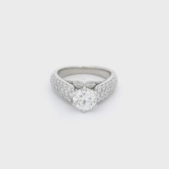 White Gold ring with a round cut diamond in the center, pavé set diamonds down the side of the shank and diamond desing on the face of the ring below the center diamond at Forever Rox Fine Jewelry