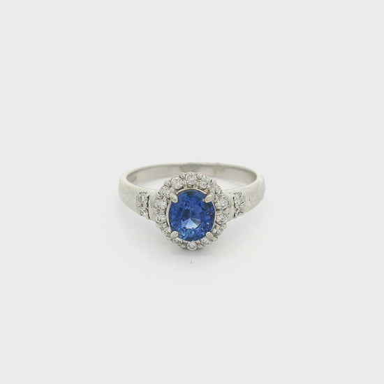 Platinum Ring with one oval cut sapphire in the center and a diamond halo with diamond accents on the band at Forever Rox Fine Jewelry