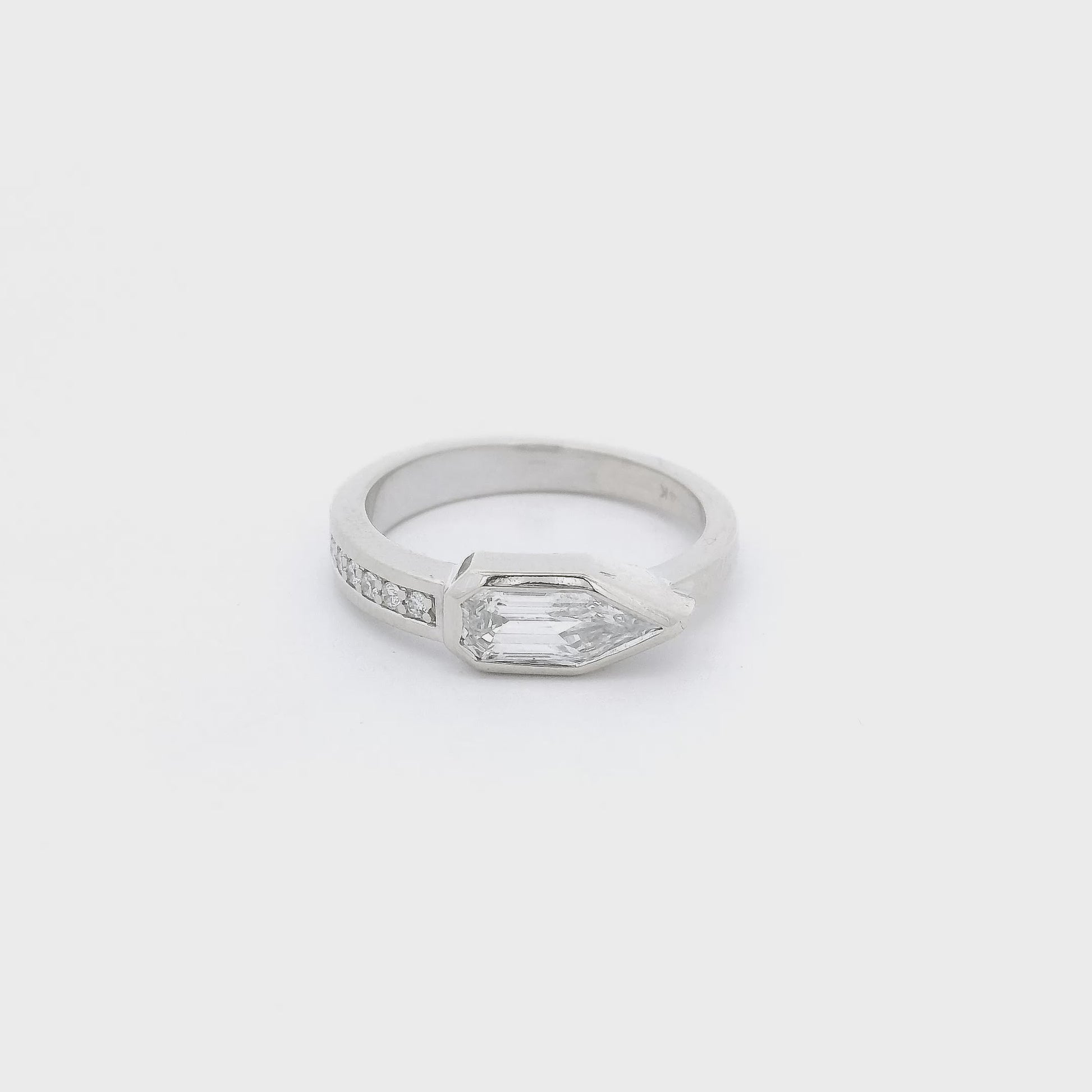 A White Gold Ring with a bezel set bullet cut natural Diamond in the center with six diamonds channel set down the band at Forever Rox Fine Jewelry, Lake Tahoes Best Jewelry Store
