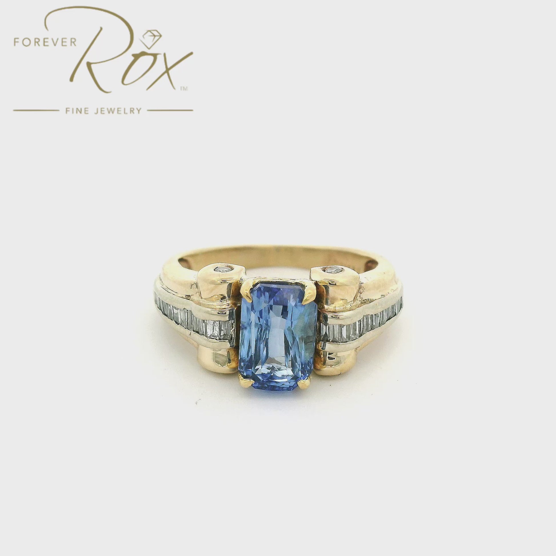 Custom gold ring with a blue ceylonese sapphire in the center and diamonds down the side made by Forever Rox Fine Jewelry