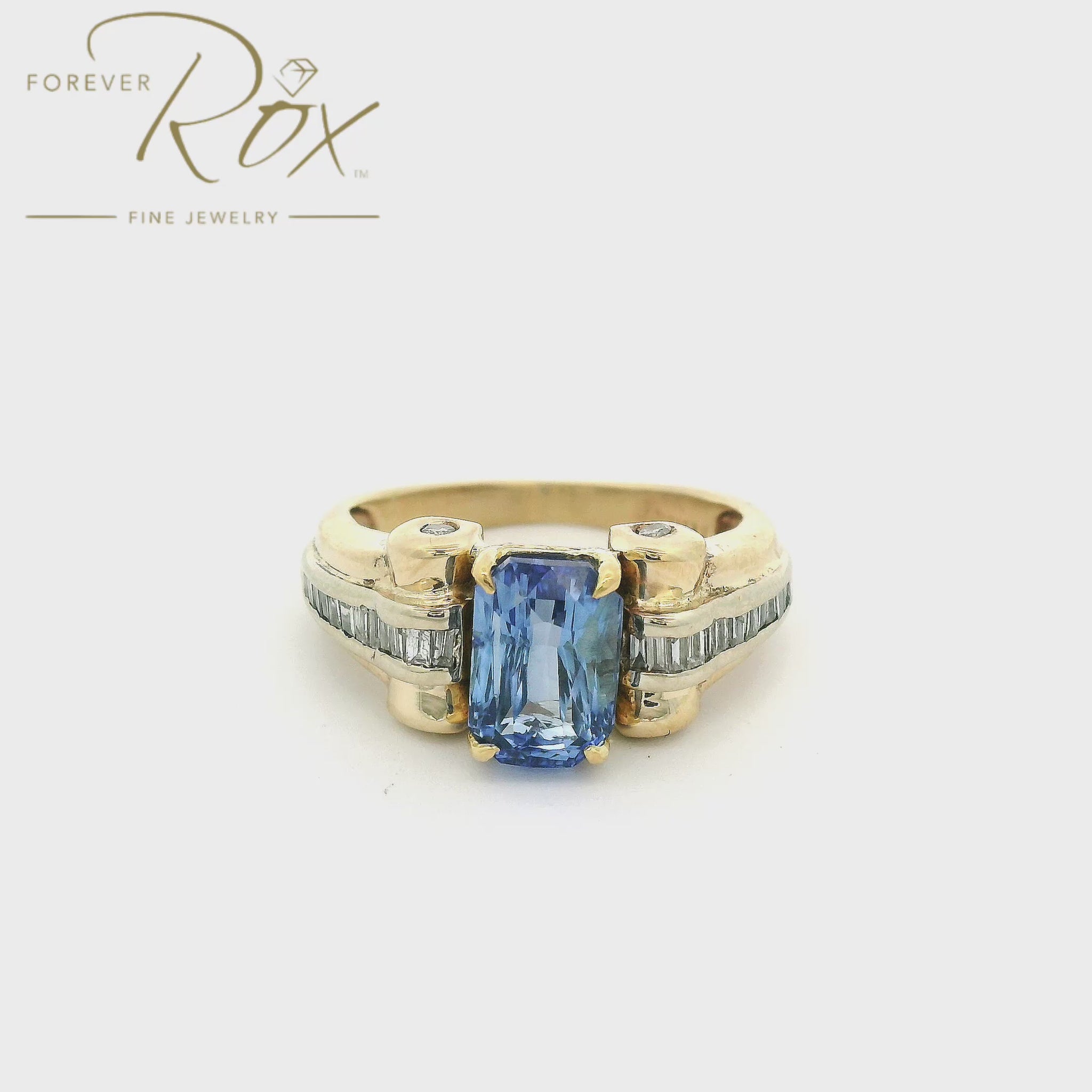 Custom gold ring with a blue ceylonese sapphire in the center and diamonds down the side made by Forever Rox Fine Jewelry