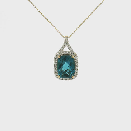 A Yellow Gold Pendant with a prong set fancy cushion cut natural London Blue Topaz in the center with a chain attached at Forever Rox Fine Jewelry, Lake Tahoes Best Jewelry Store