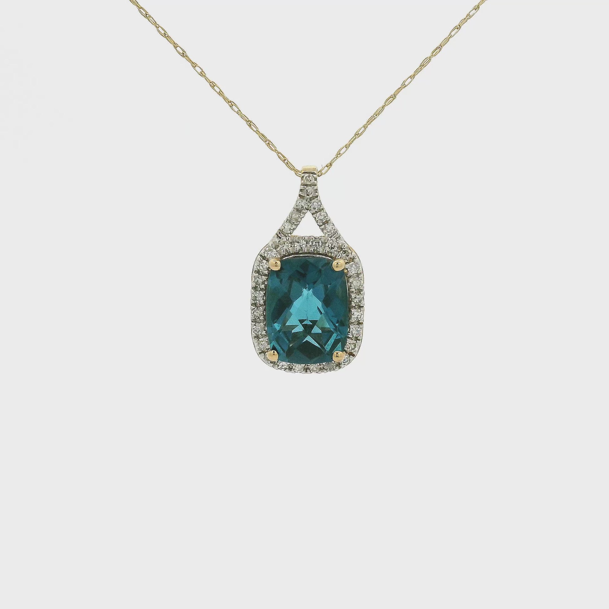 A Yellow Gold Pendant with a prong set fancy cushion cut natural London Blue Topaz in the center with a chain attached at Forever Rox Fine Jewelry, Lake Tahoes Best Jewelry Store