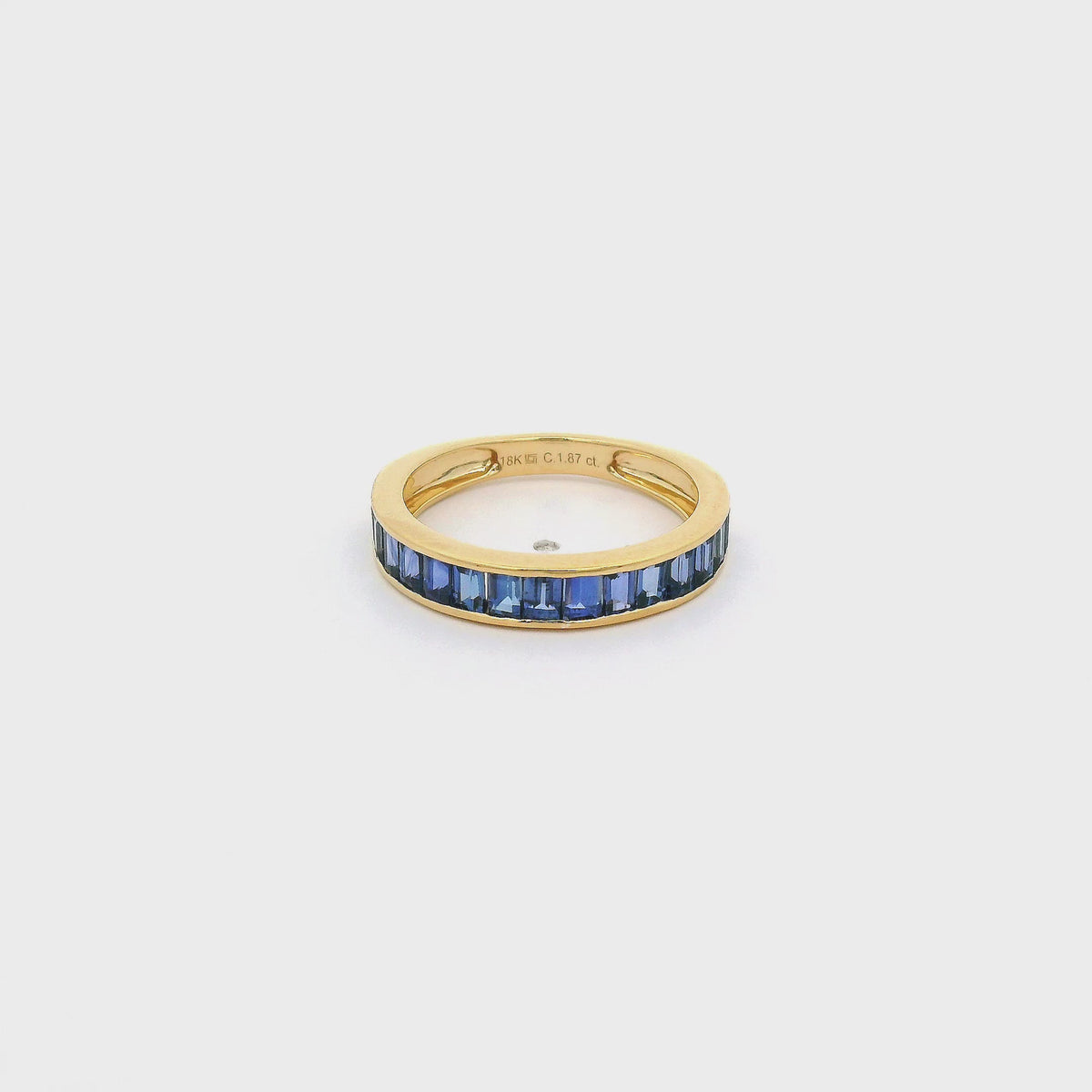 A Yellow Gold Band with channel set baguette cut natural Sapphires in the center at Forever Rox Fine Jewelry, Lake Tahoes Best Jewelry Store
