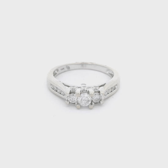 White Gold ring with three diamonds set in center with the center one bigger than the other two and four diamonds channel set down each side of the shank at Forever Rox Fine Jewelry