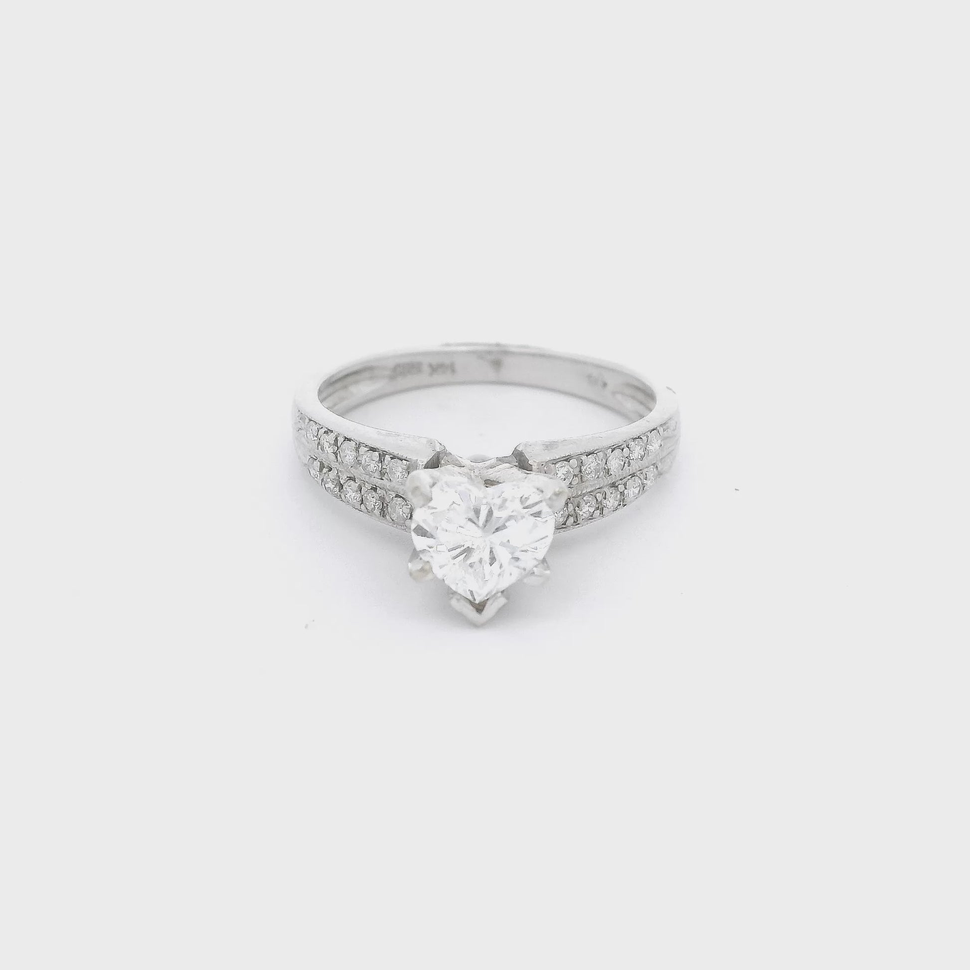 White Gold ring with a heart shape diamond in the center and tow rows of diamonds down each shank at Forever Rox Fine Jewelry