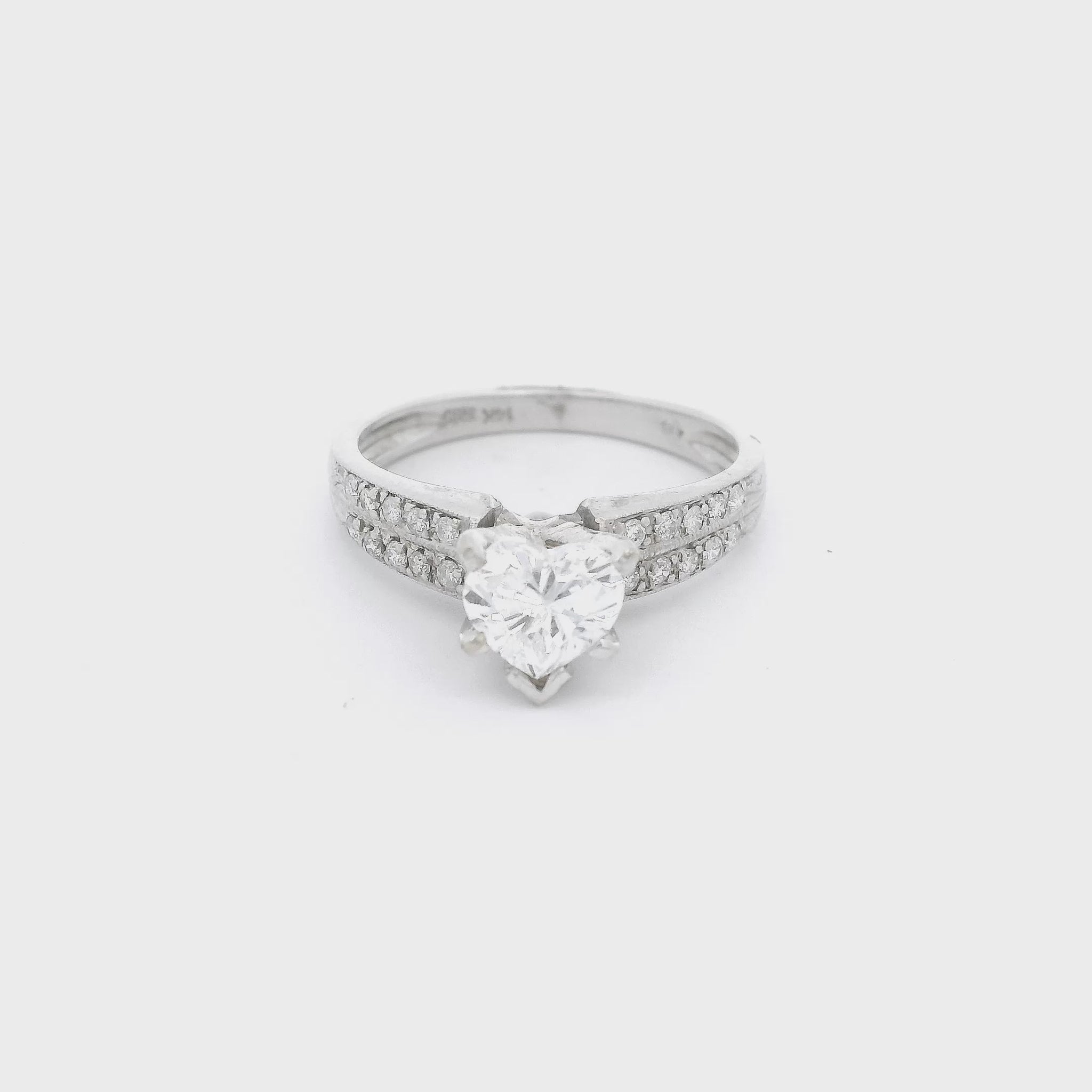 White Gold ring with a heart shape diamond in the center and tow rows of diamonds down each shank at Forever Rox Fine Jewelry