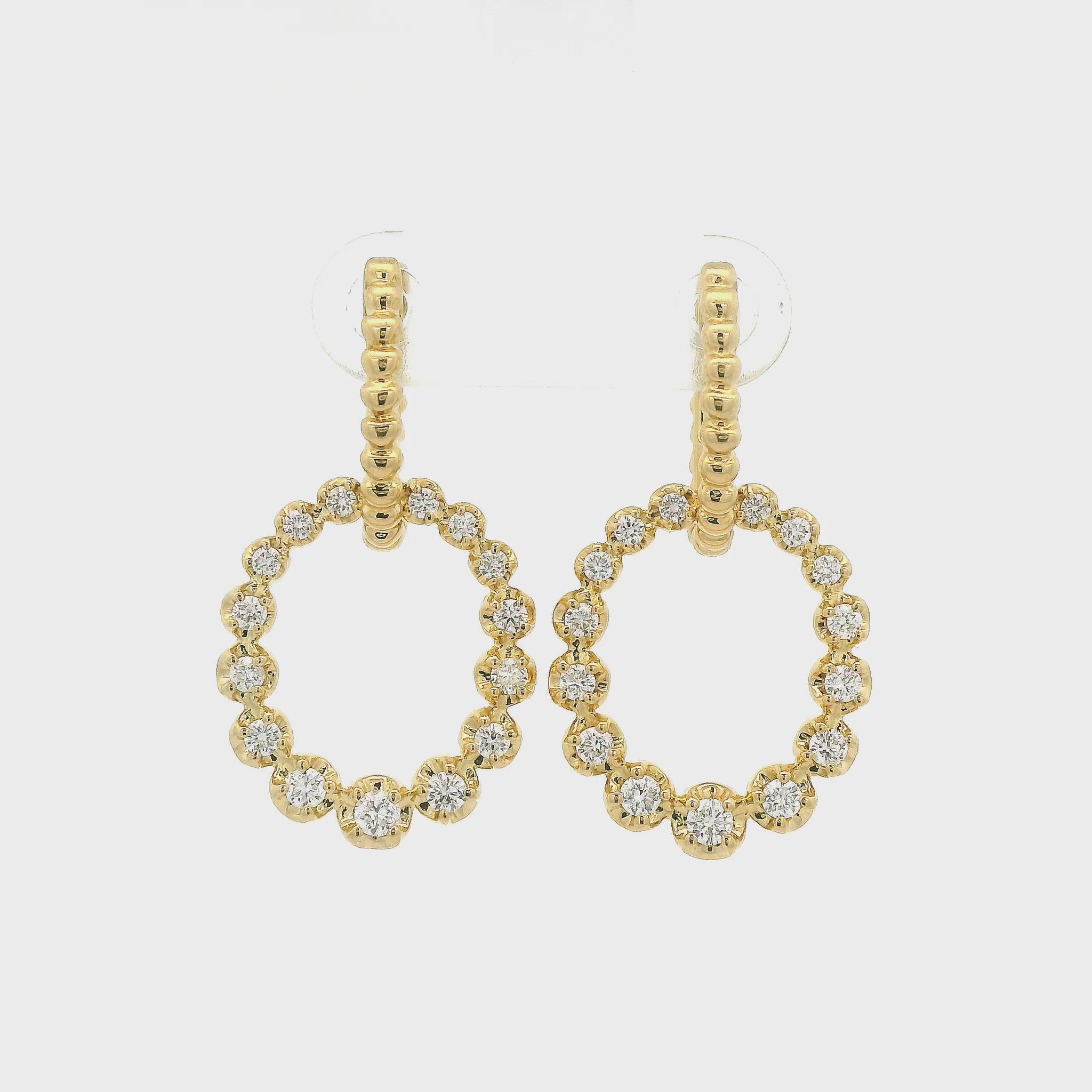 A Pair of Yellow Gold Dangle Earrings with circles dangling set with diamonds all around them at Forever Rox Fine Jewelry, Lake Tahoes Best Jewelry Store