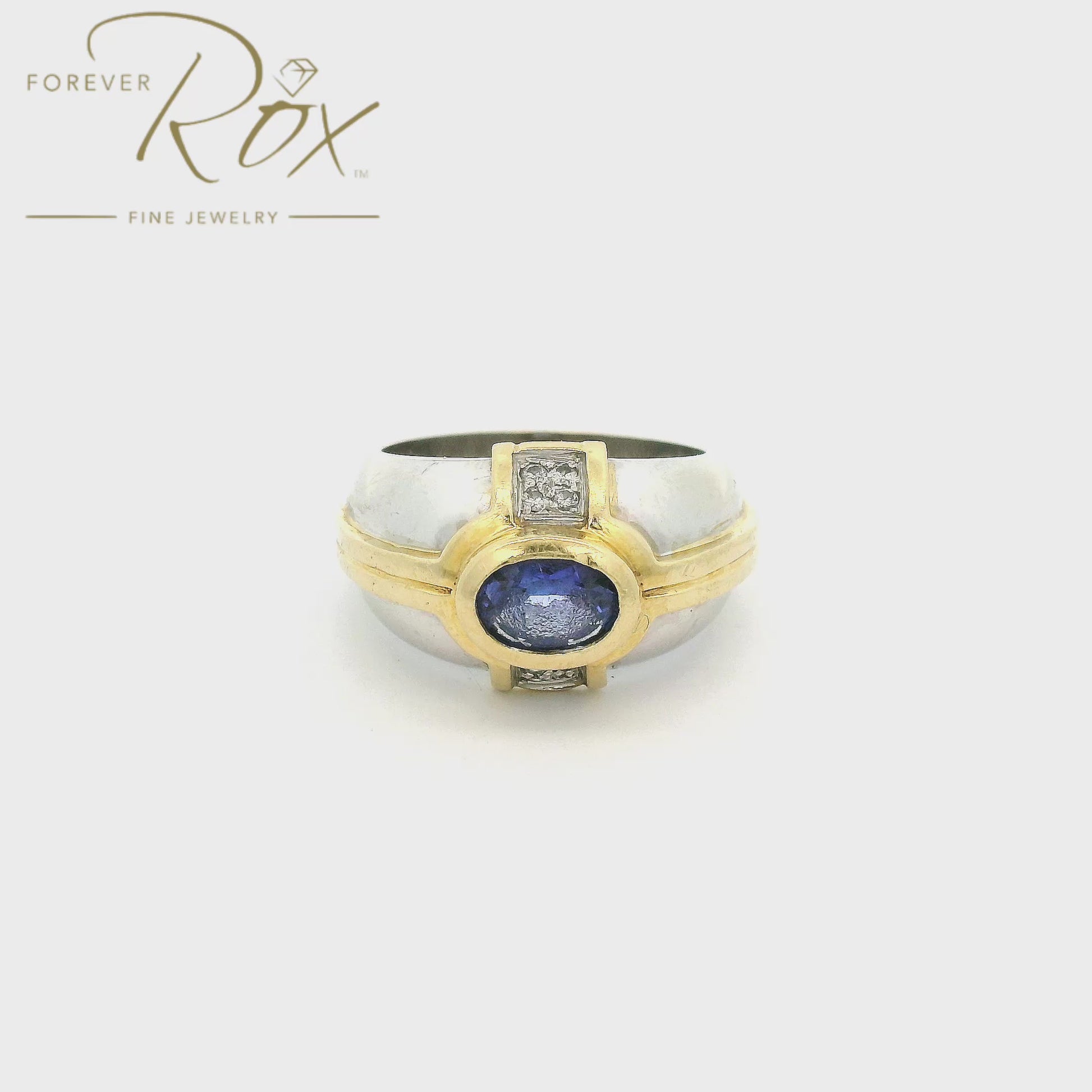 A White & Yellow Gold Ring with a bezel set oval cut natural Tanzanite in the center with 4 diamonds on either side at Forever Rox Fine Jewelry, Lake Tahoes Best Jewelry Store