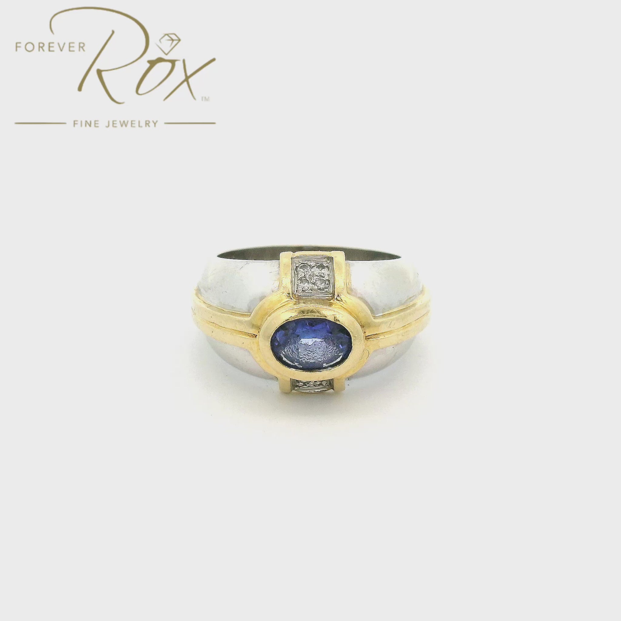 A White & Yellow Gold Ring with a bezel set oval cut natural Tanzanite in the center with 4 diamonds on either side at Forever Rox Fine Jewelry, Lake Tahoes Best Jewelry Store